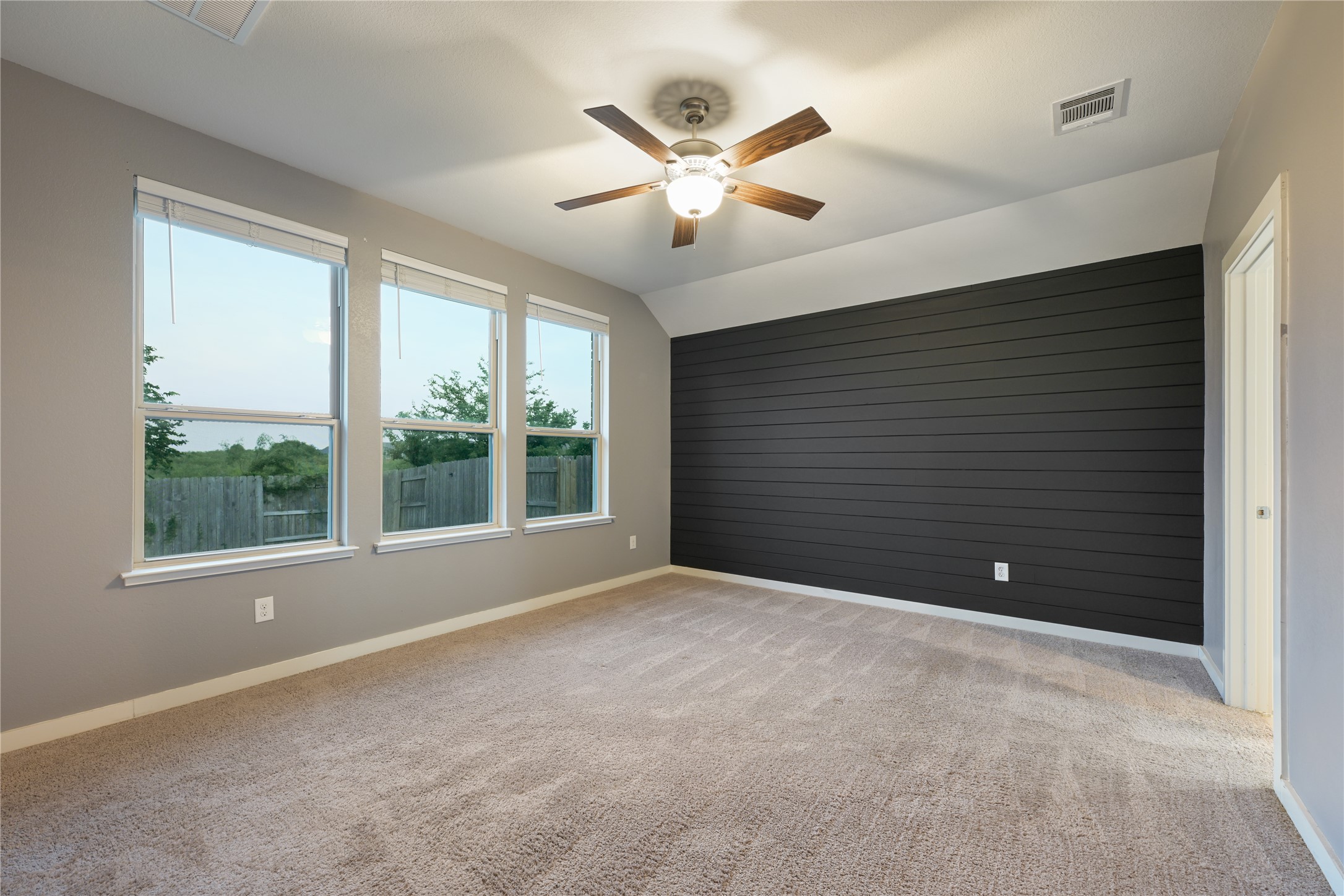 188 Nautical Loop Kyle, TX 78640 - Photo 19 of 38 A restful chamber offers a shiplap accent wall and abundant natural light.