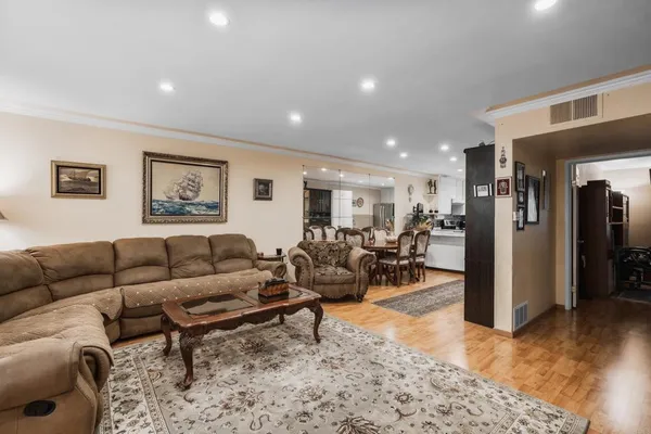 a living room with furniture and a wooden floor