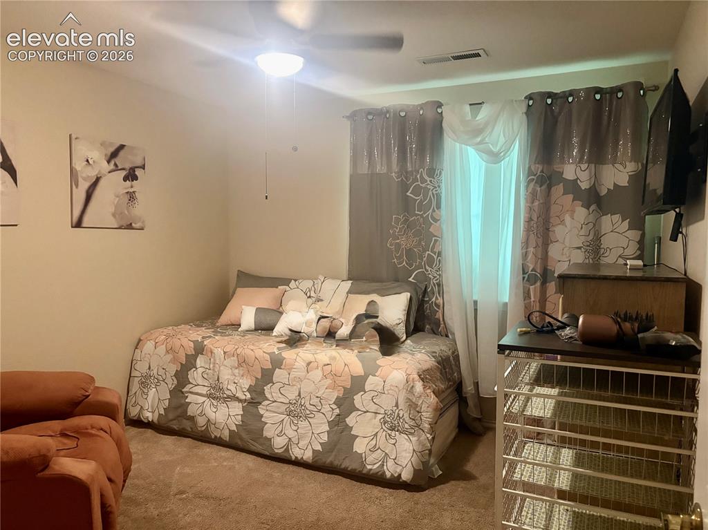 3748 Riviera Grove, Unit 203 Colorado Springs, CO 80922 - Photo 20 of 23 a bedroom with a bed and a window