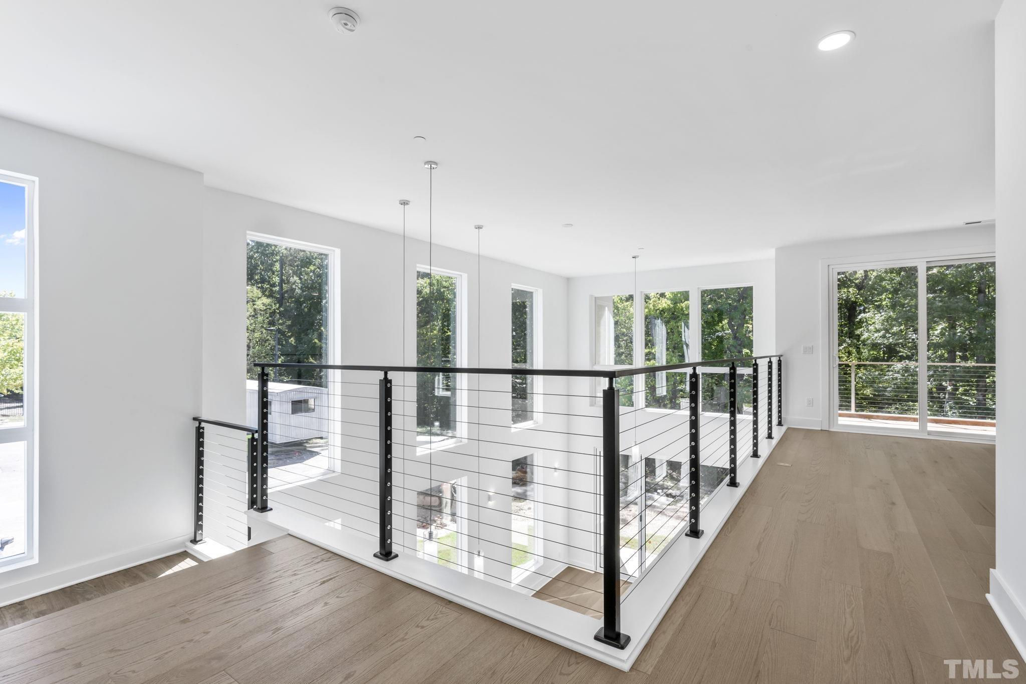 4009 Southpoint Landing Way, Unit 5 Durham, NC 27707 - Photo 15 of 43 a view of staircase with wooden floor and windows