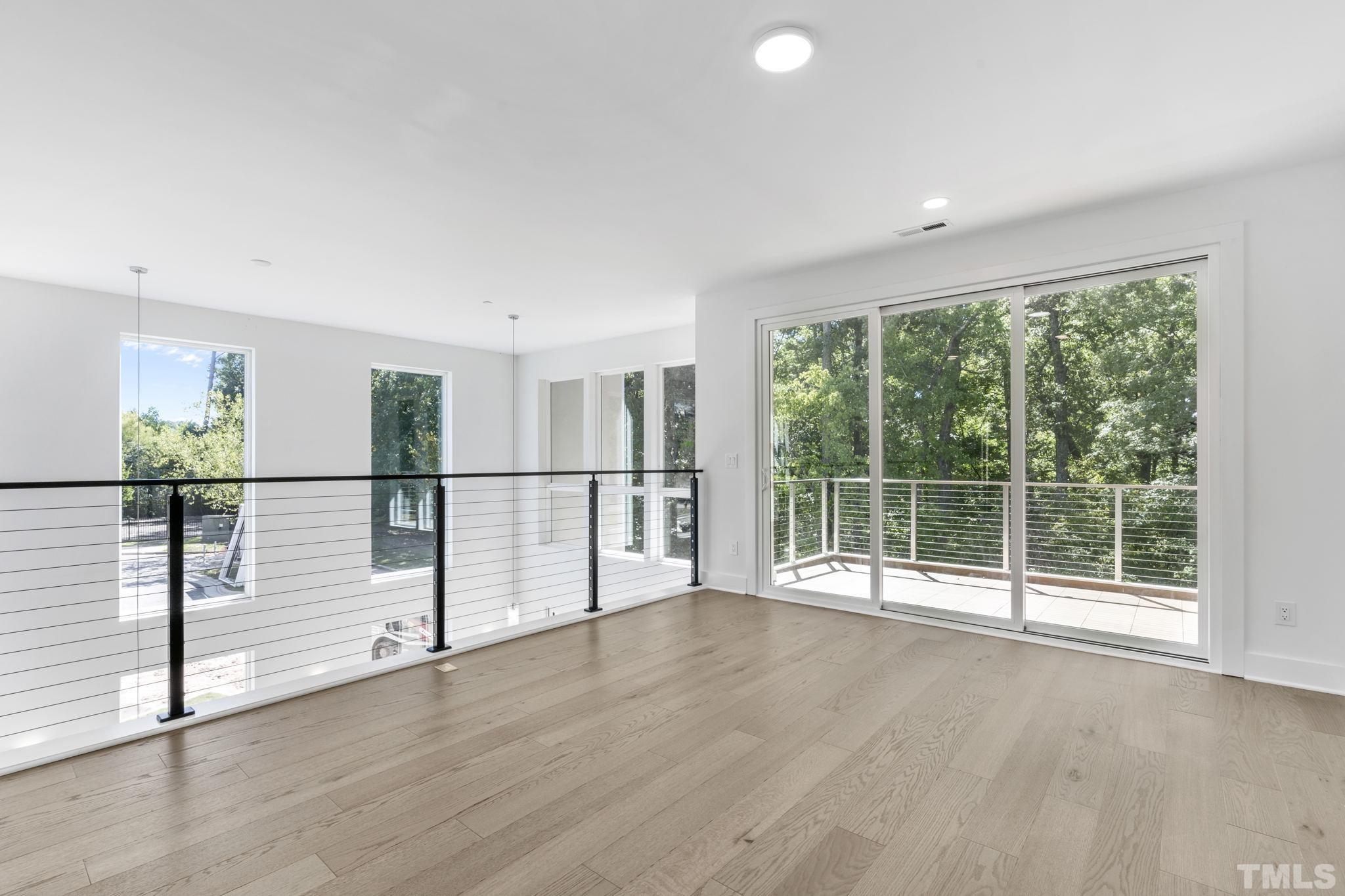 4009 Southpoint Landing Way, Unit 5 Durham, NC 27707 - Photo 19 of 43 a view of an empty room with wooden floor and a window