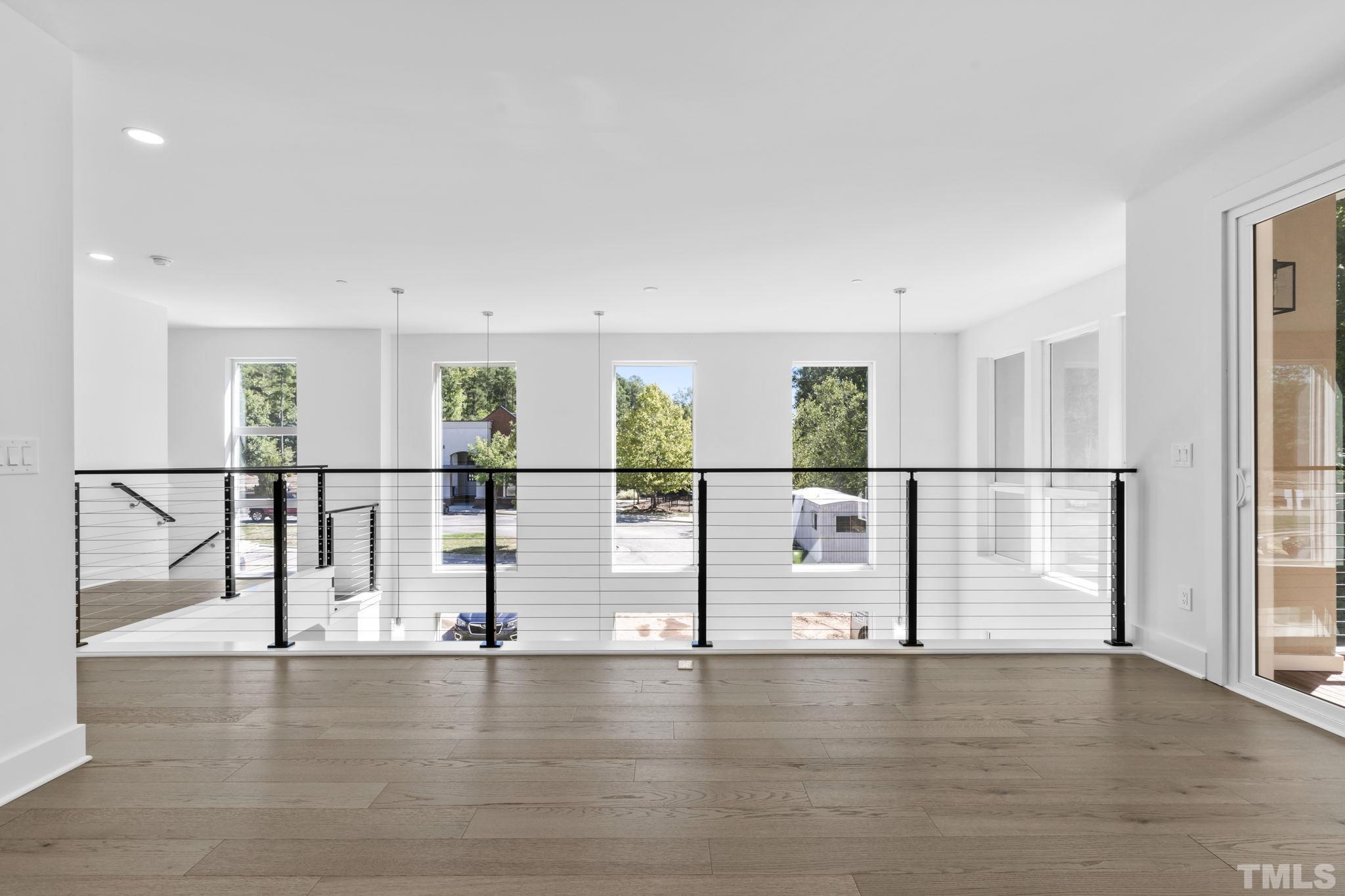4009 Southpoint Landing Way, Unit 5 Durham, NC 27707 - Photo 20 of 43 a view of a living room hardwood floor and windows