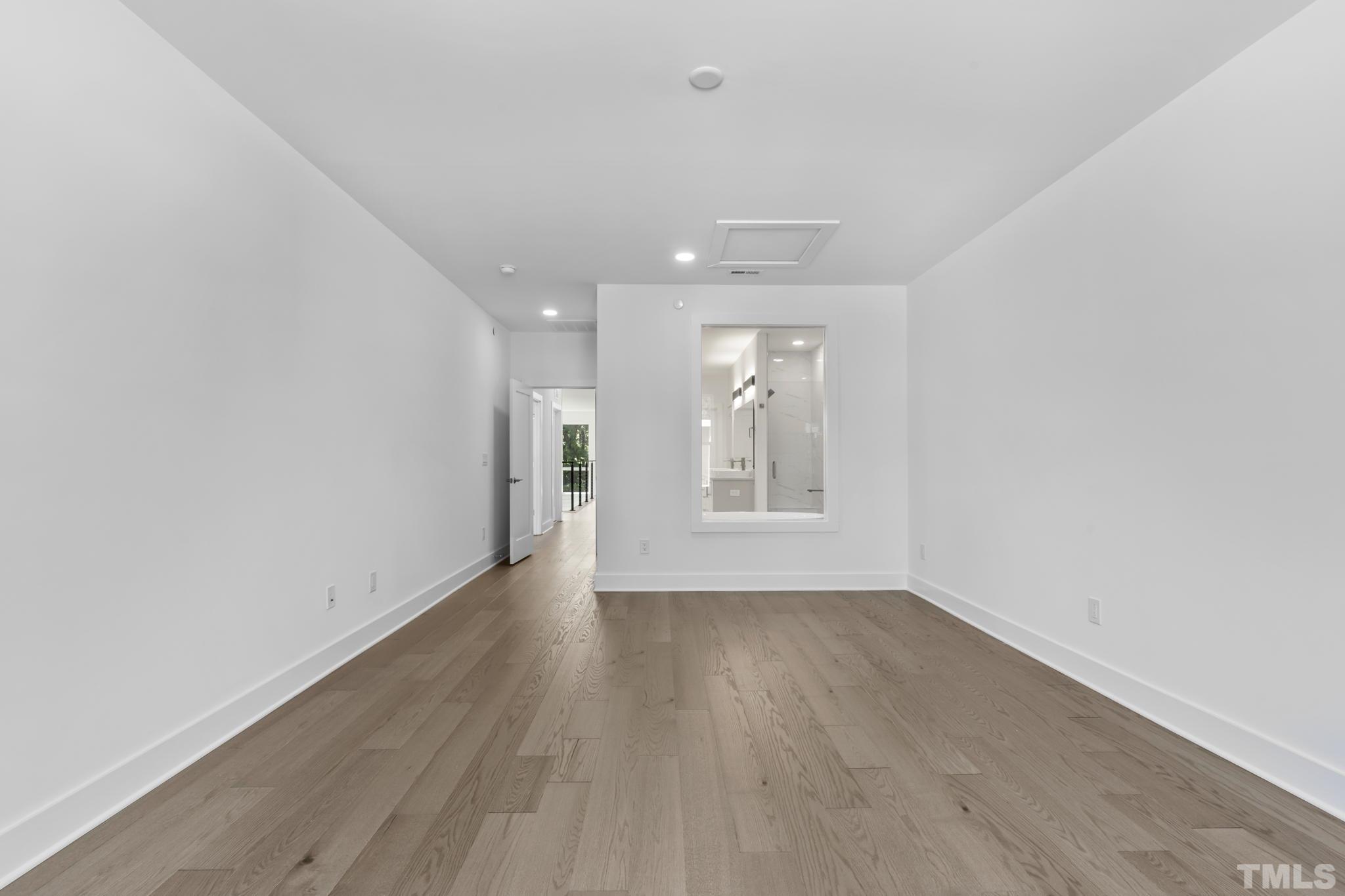 4009 Southpoint Landing Way, Unit 5 Durham, NC 27707 - Photo 22 of 43 an empty room with wooden floor and windows