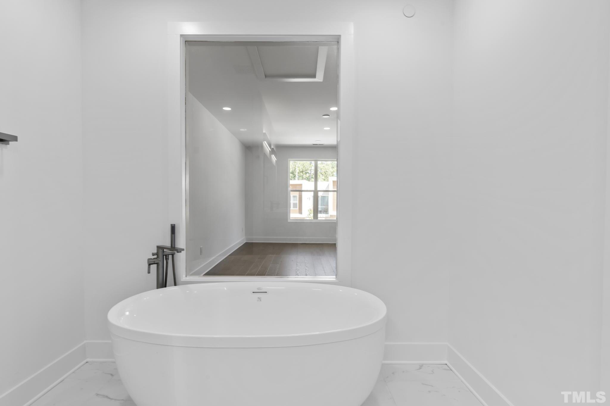 4009 Southpoint Landing Way, Unit 5 Durham, NC 27707 - Photo 25 of 43 a white bath tub sitting in a bathroom