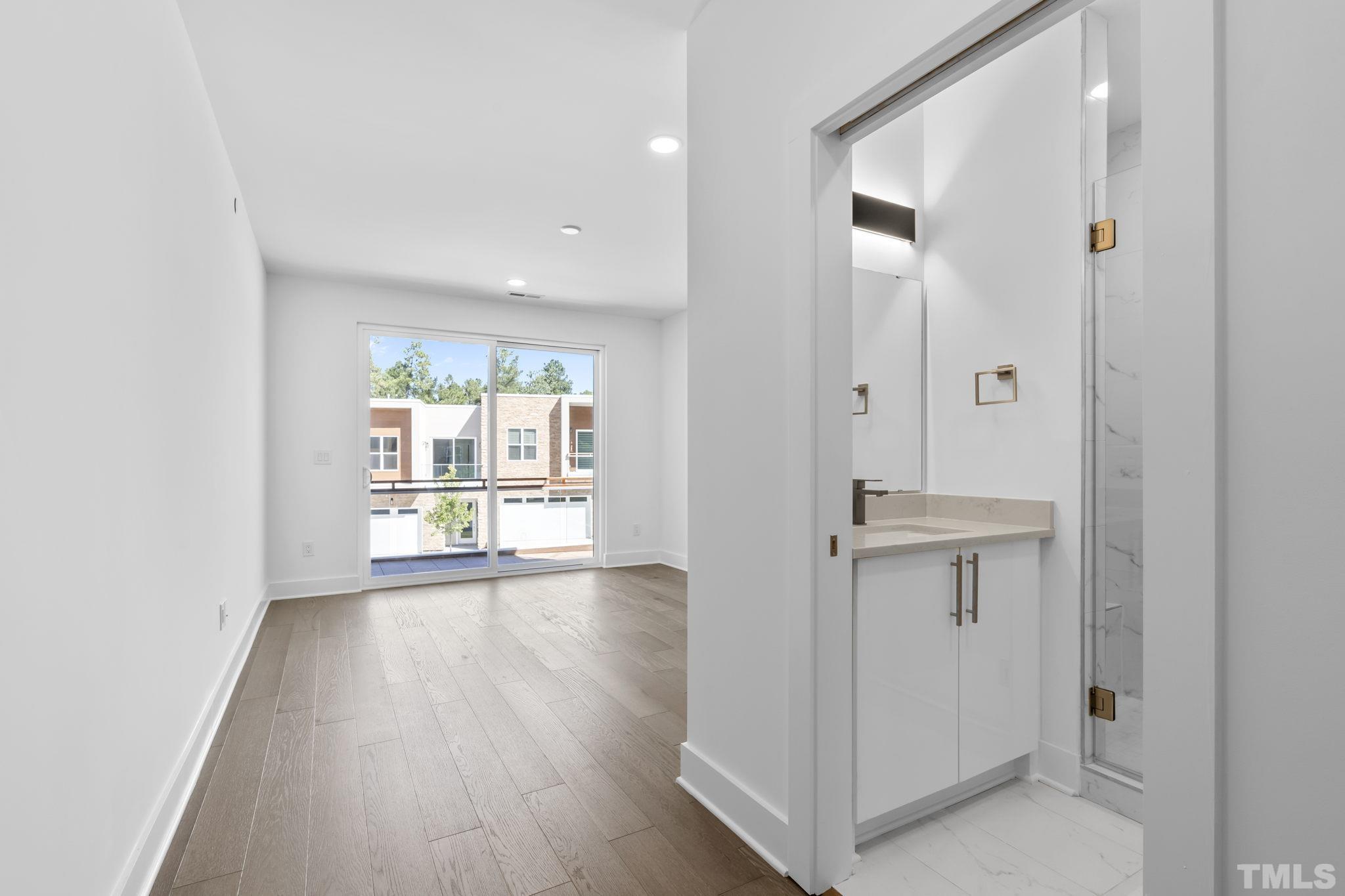 4009 Southpoint Landing Way, Unit 5 Durham, NC 27707 - Photo 26 of 43 a view of an empty room with a window and wooden floor