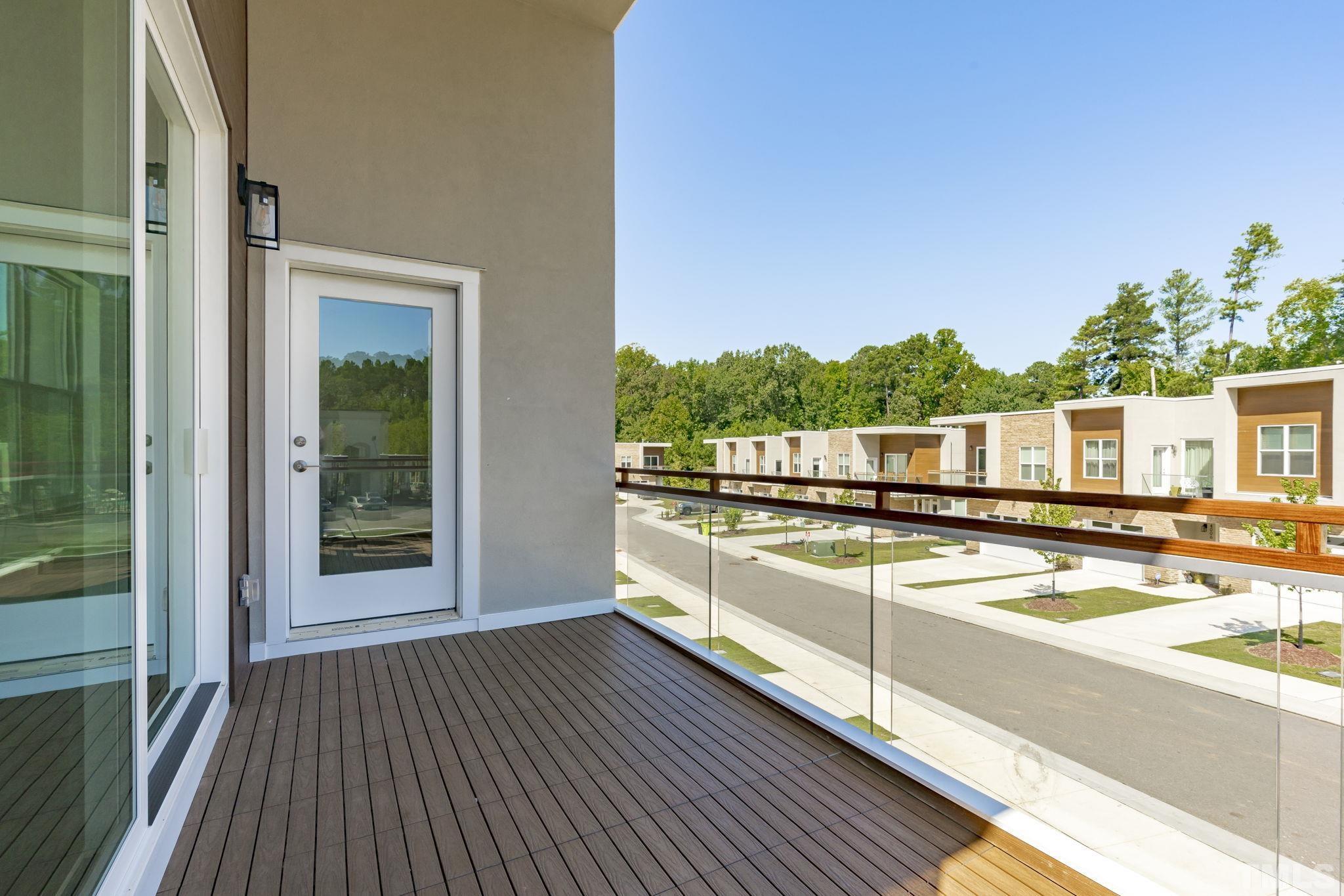 4009 Southpoint Landing Way, Unit 5 Durham, NC 27707 - Photo 29 of 43 a view of a balcony with chairs and wooden floor