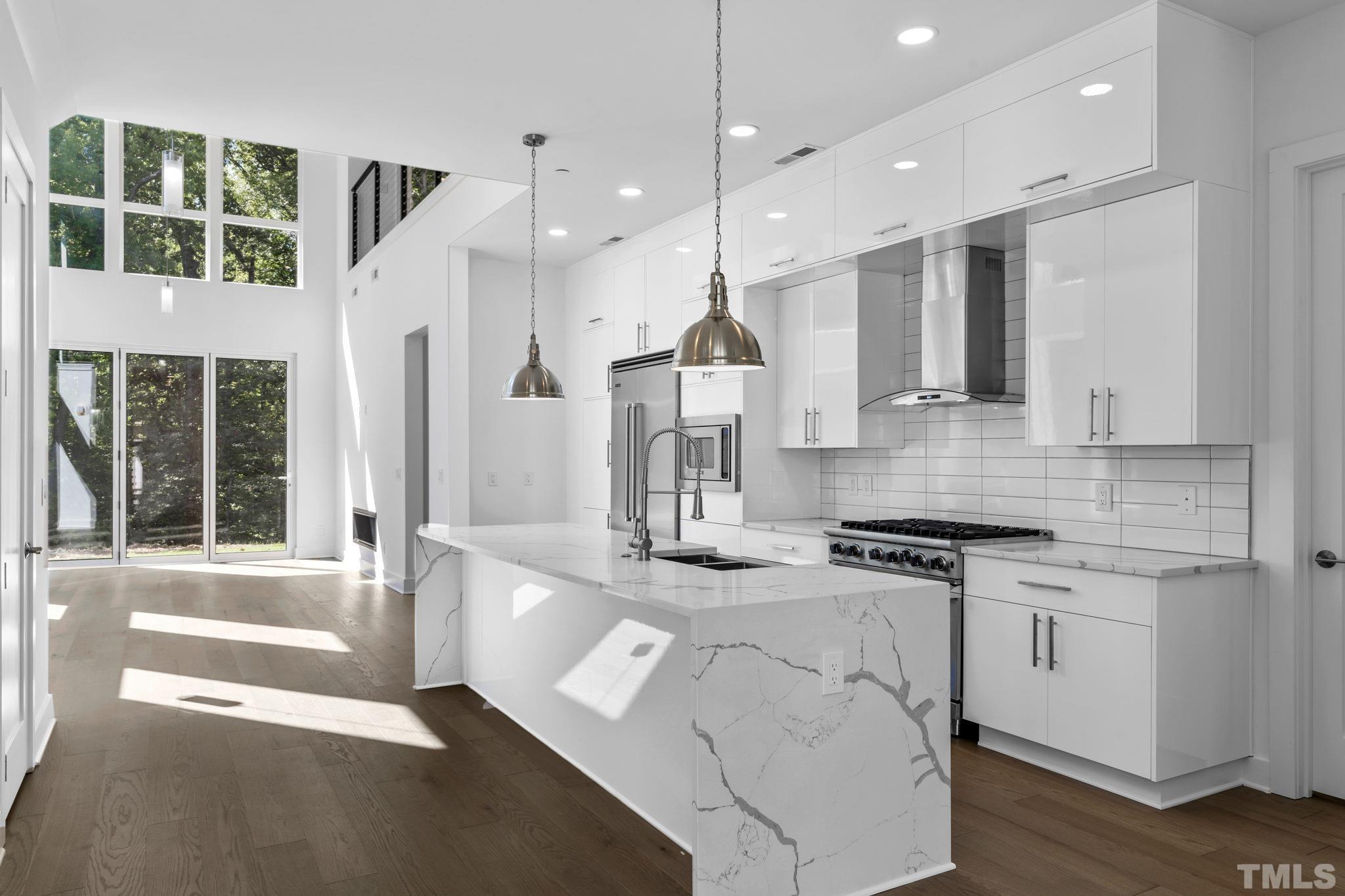 4009 Southpoint Landing Way, Unit 5 Durham, NC 27707 - Photo 4 of 43 a kitchen with stainless steel appliances granite countertop a stove a sink and a refrigerator