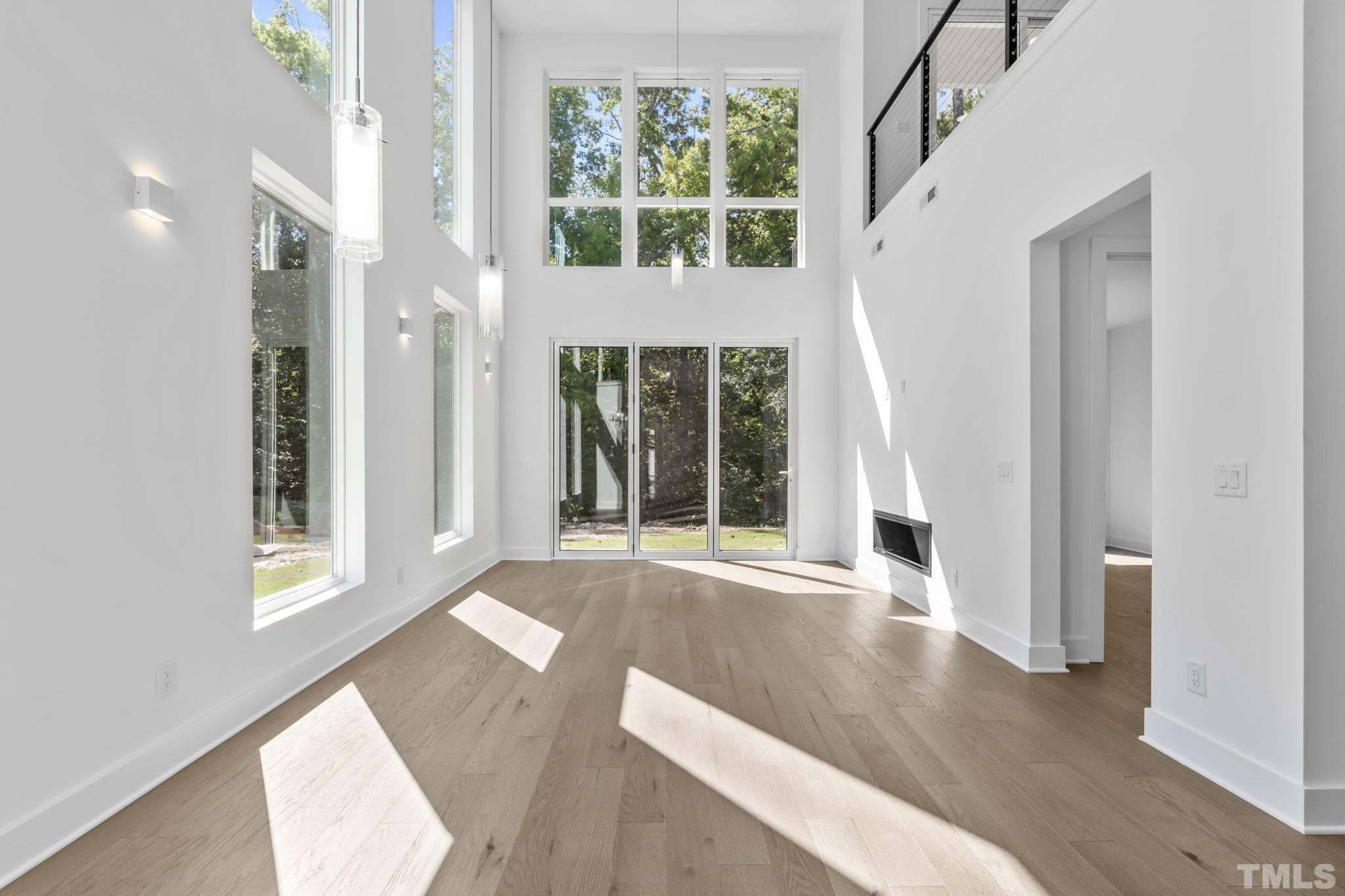 4009 Southpoint Landing Way, Unit 5 Durham, NC 27707 - Photo 5 of 43 a view of an empty room with wooden floor and a window