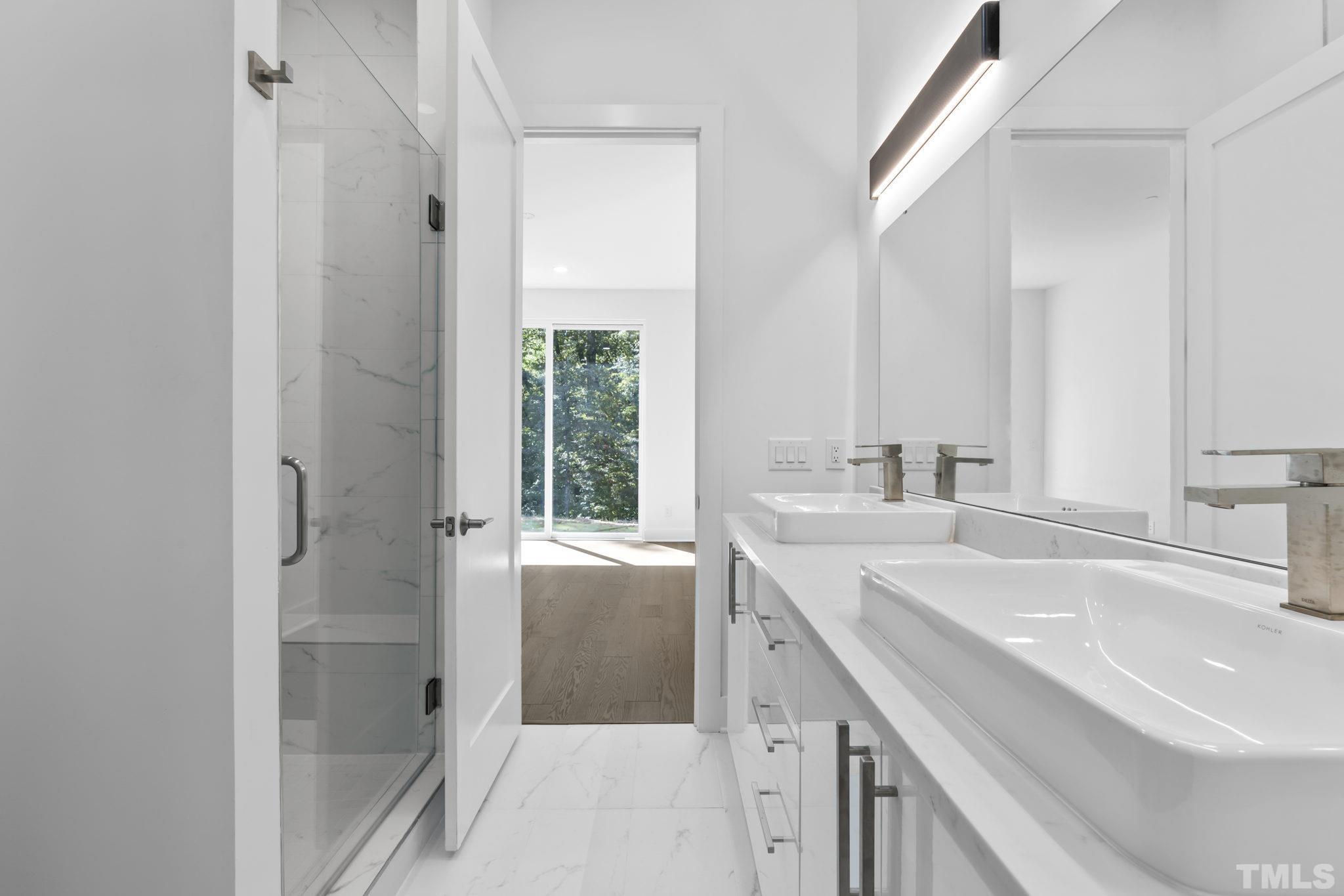 4009 Southpoint Landing Way, Unit 5 Durham, NC 27707 - Photo 8 of 43 a bathroom with a sink a mirror and a shower