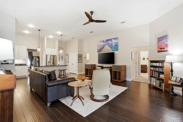 a bedroom with a bed and a flat tv screen on dresser