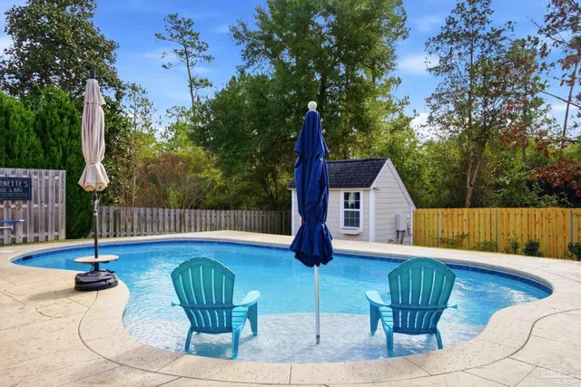 a kitchen with stainless steel appliances granite countertop a kitchen island a stove a table and chairs in it