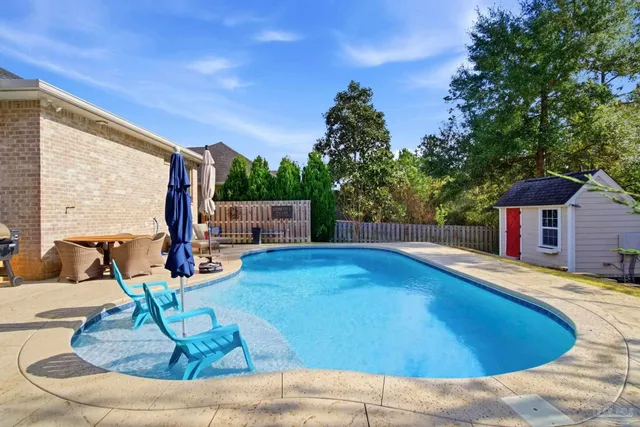 a view of a porch with chairs and plants
