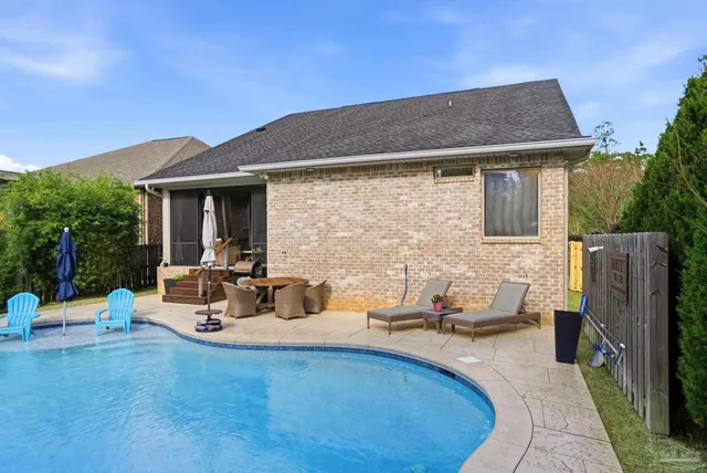 a view of a house with a yard and potted plants