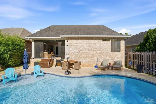 a view of house with outdoor space and swimming pool