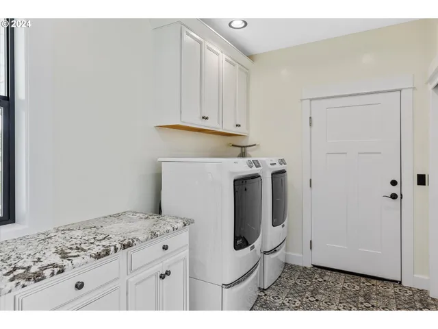 a bathroom with a granite countertop toilet sink and mirror