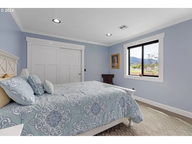 a bedroom with a bed and a television