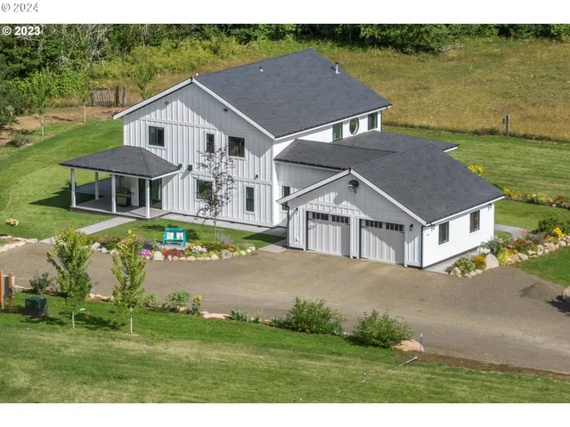 a aerial view of a house next to a yard and lake view