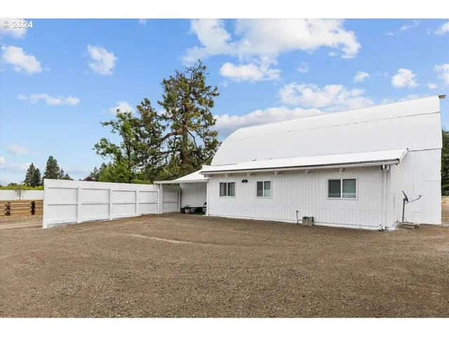 a view of a big yard with large trees