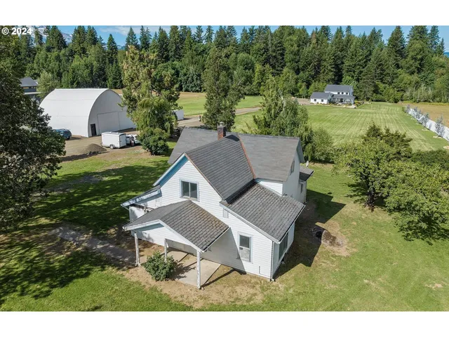 a view of a house with a yard patio and furniture