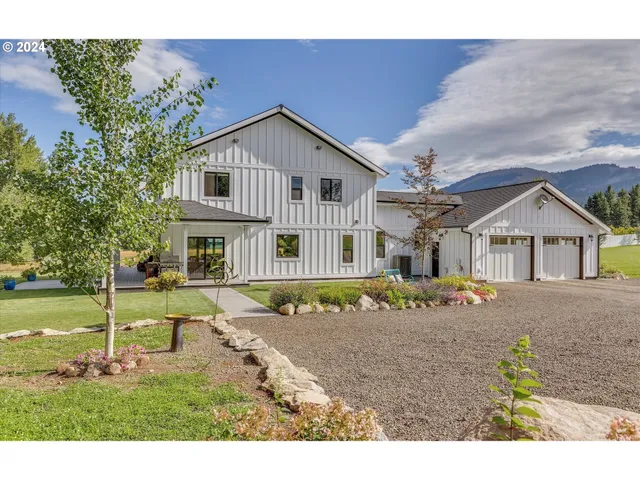 a view of a house with entrance stairs and a yard