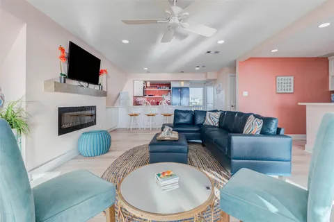 a living room with fireplace furniture and a flat screen tv