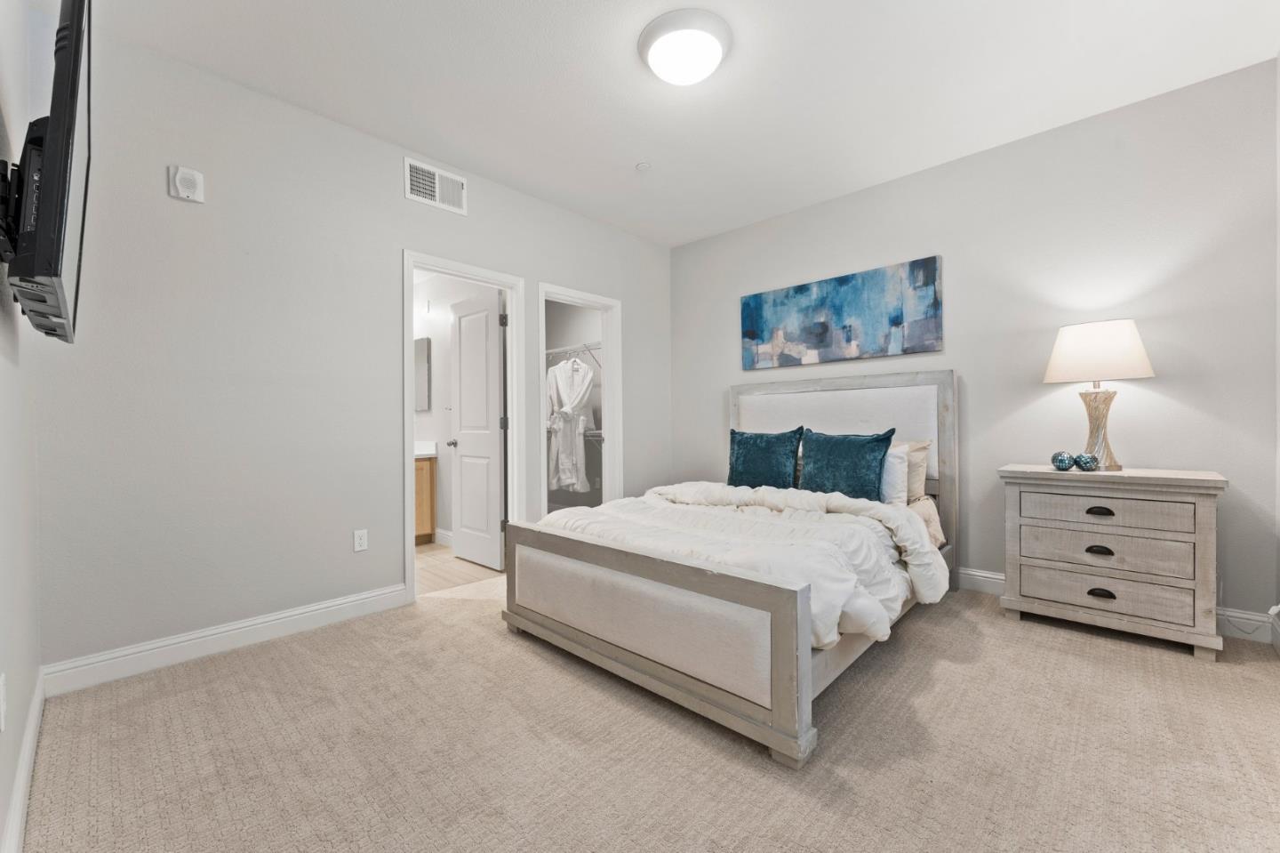 435 Montague Expressway Milpitas, CA 95035 - Photo 4 of 46 a spacious bedroom with a bed and a lamp