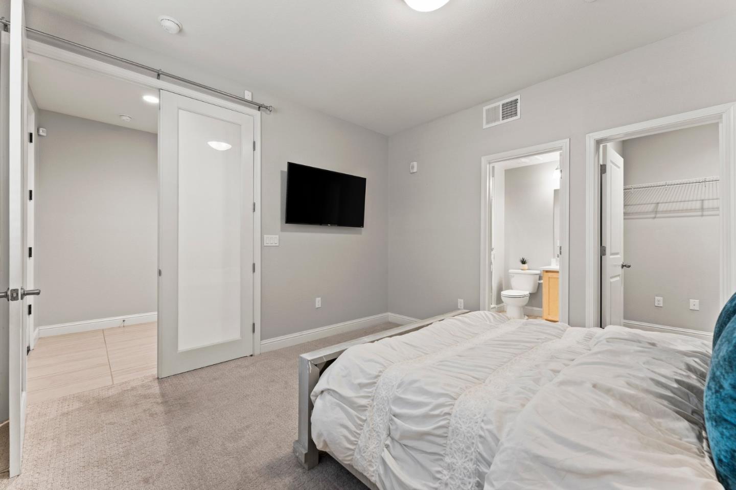 435 Montague Expressway Milpitas, CA 95035 - Photo 5 of 46 a bedroom with a bed and a flat screen tv