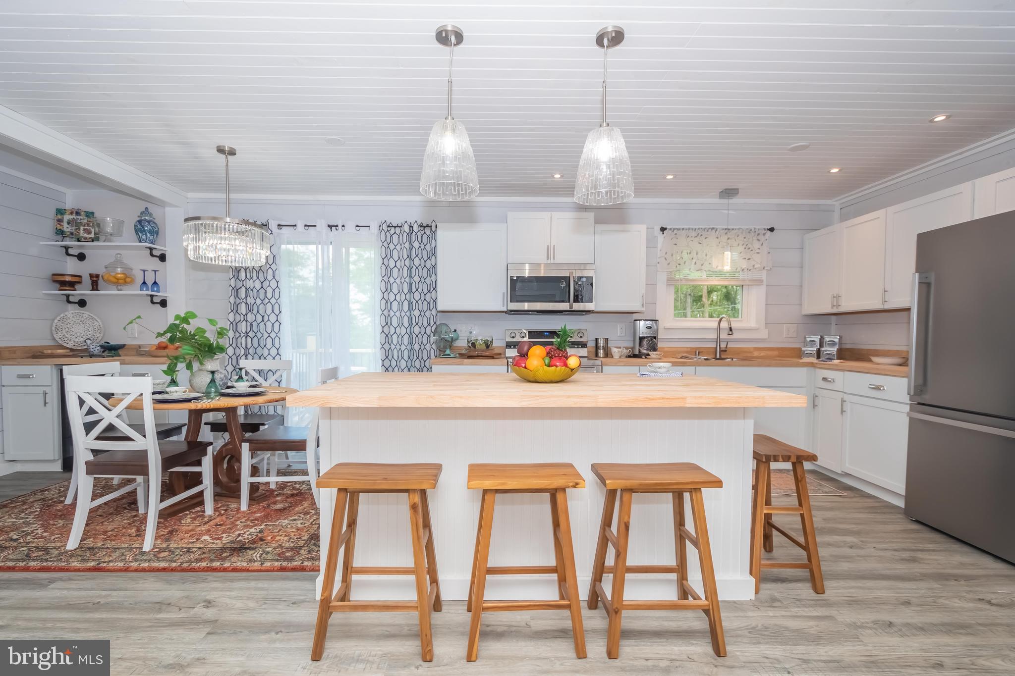 4211 Chestnut Ridge Road Grantsville, MD 21536 - Photo 11 of 43 a kitchen with stainless steel appliances granite countertop a dining table chairs refrigerator and sink