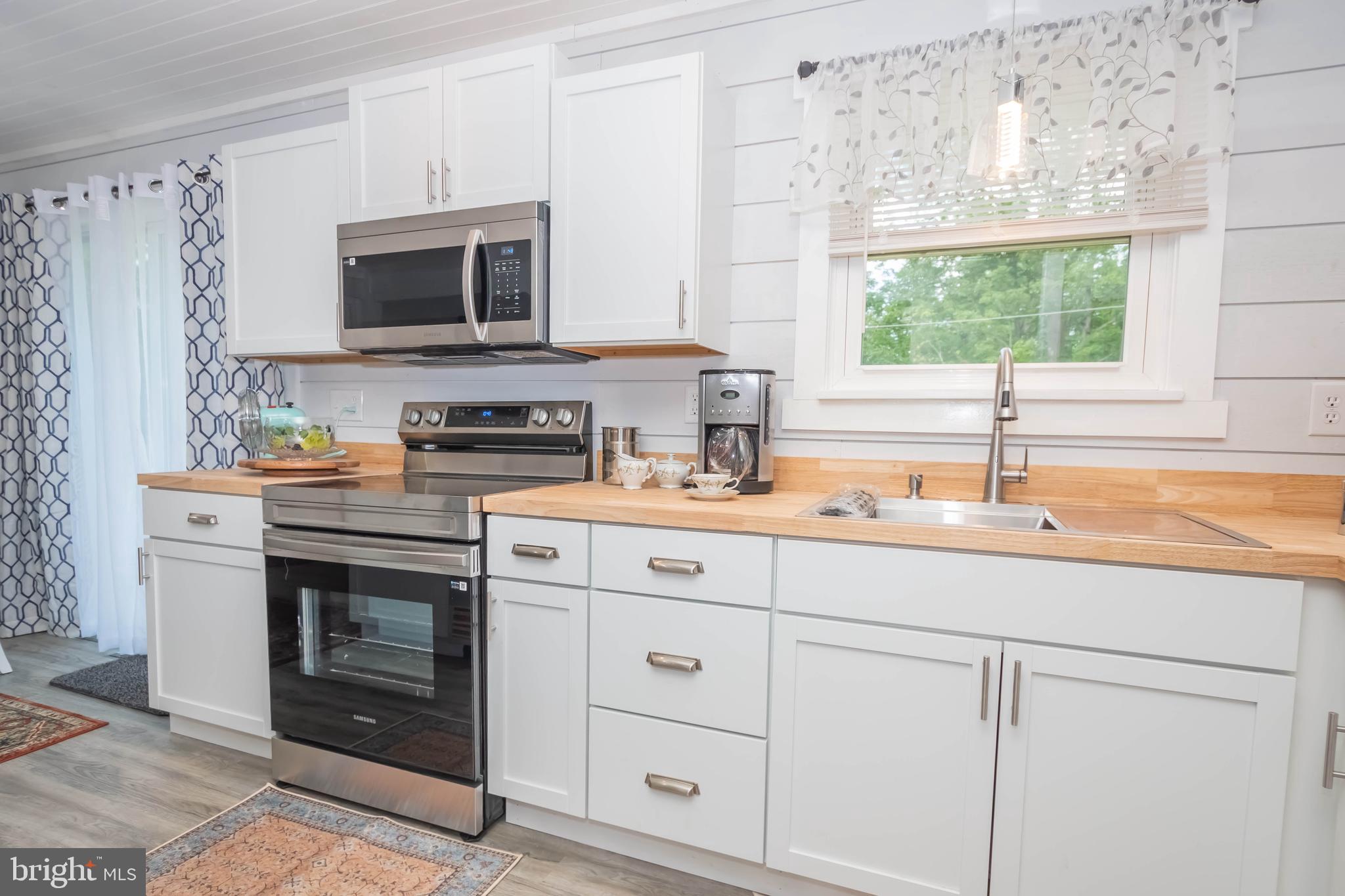 4211 Chestnut Ridge Road Grantsville, MD 21536 - Photo 14 of 43 a kitchen with stainless steel appliances a stove sink and microwave