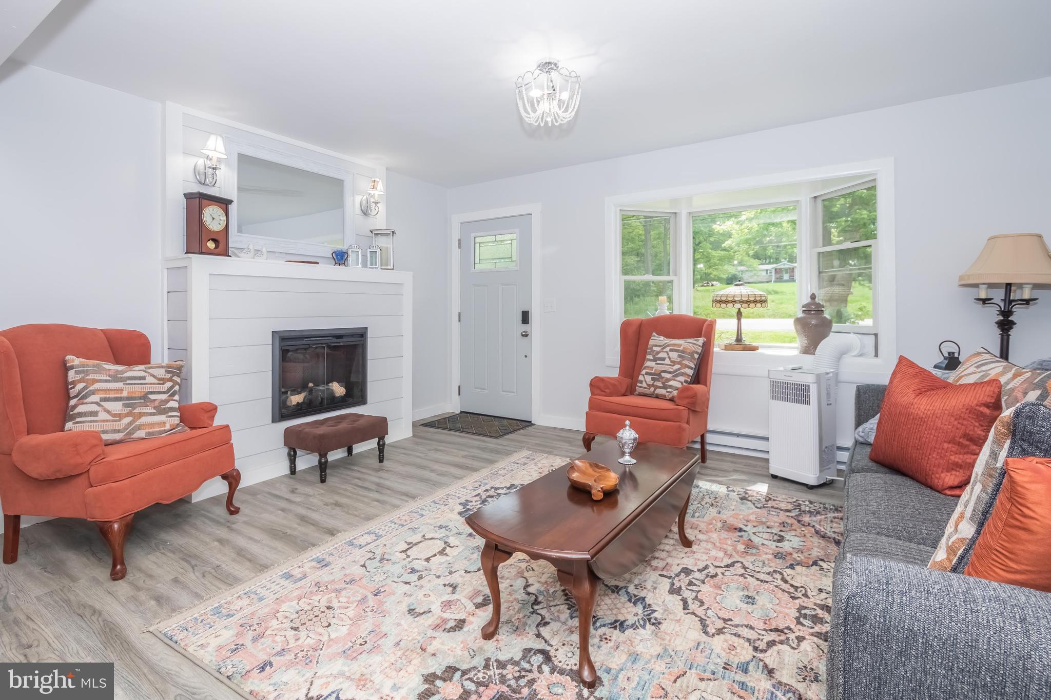 4211 Chestnut Ridge Road Grantsville, MD 21536 - Photo 21 of 43 a living room with furniture a rug and a fireplace