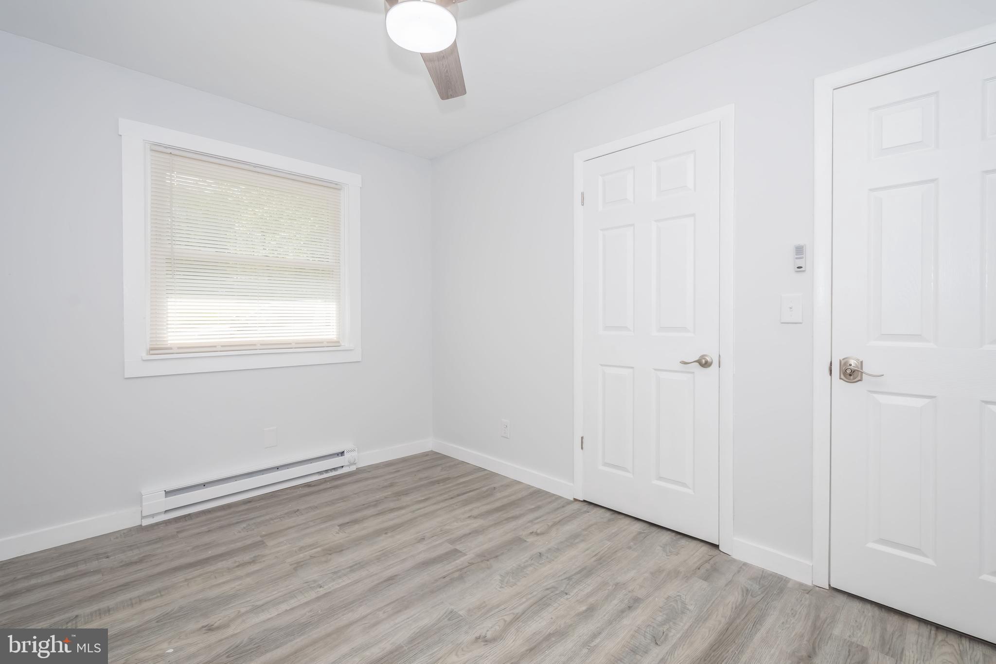 4211 Chestnut Ridge Road Grantsville, MD 21536 - Photo 27 of 43 an empty room with wooden floor and windows
