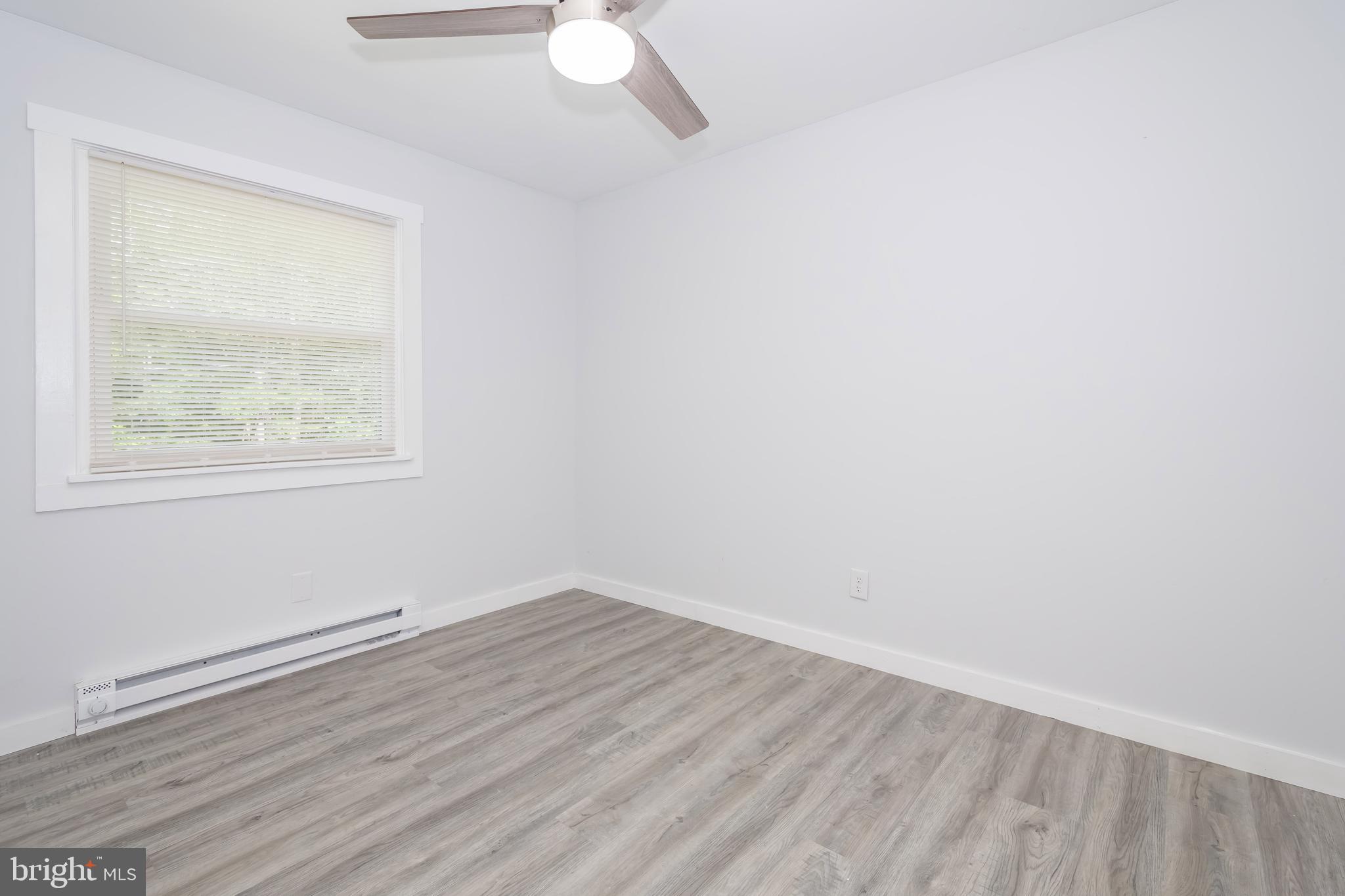 4211 Chestnut Ridge Road Grantsville, MD 21536 - Photo 30 of 43 an empty room with wooden floor and windows