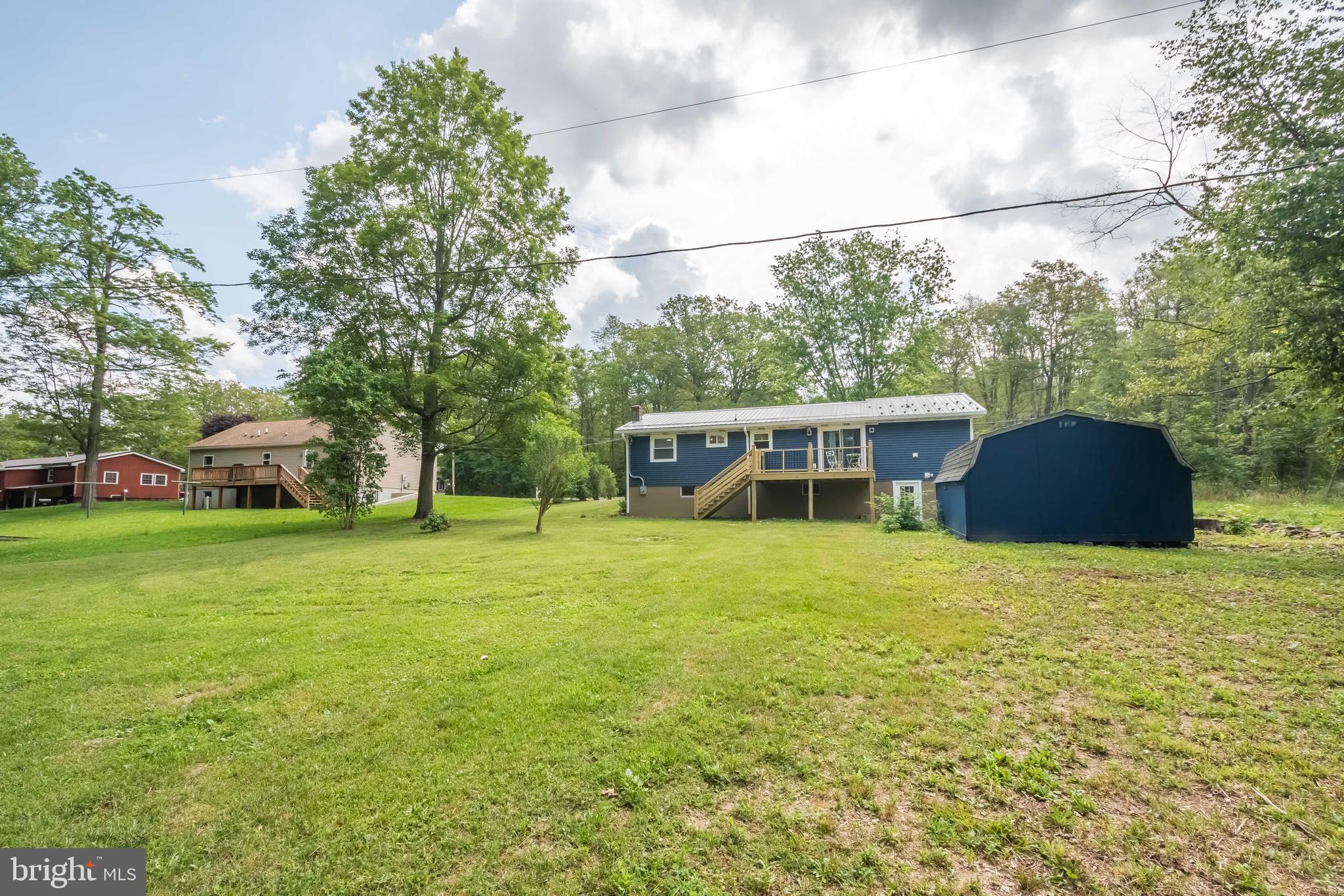 4211 Chestnut Ridge Road Grantsville, MD 21536 - Photo 4 of 43 a front view of a house with a garden