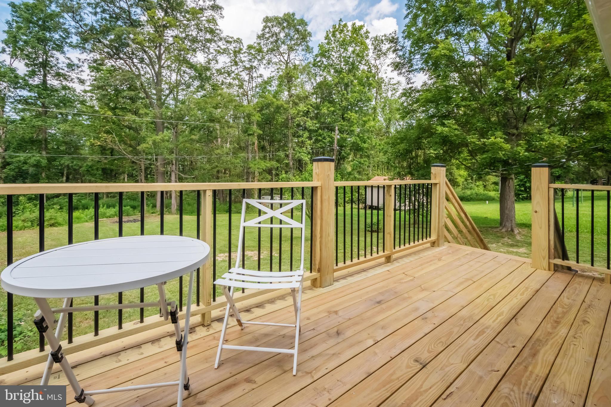 4211 Chestnut Ridge Road Grantsville, MD 21536 - Photo 6 of 43 a view of a balcony with two chairs and a table