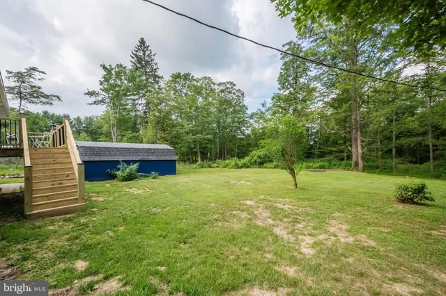 a backyard of a house with lots of green space