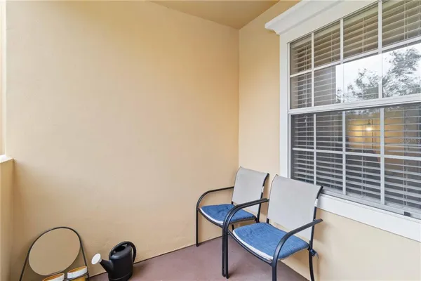a balcony with table and a chair