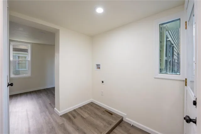 a view of an empty room and wooden floor