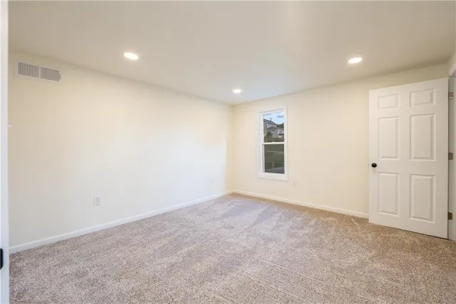 an empty room with windows and closet