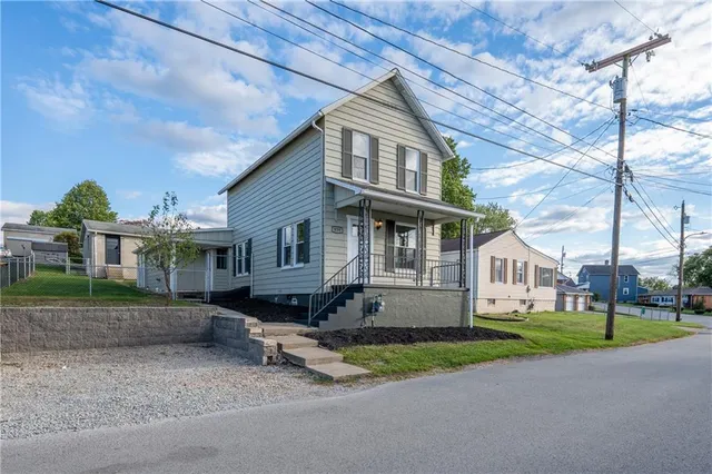 a front view of a house with a yard and table and chairs