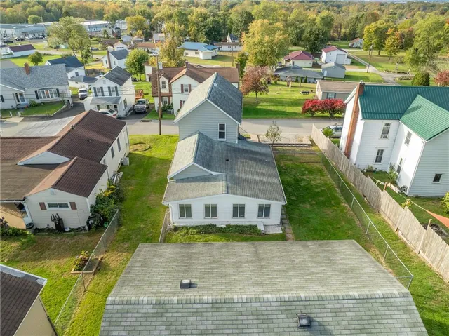 an aerial view of a house with a yard and lake view