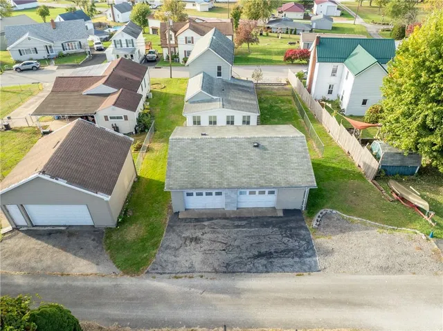 an aerial view of a house with a yard and pool