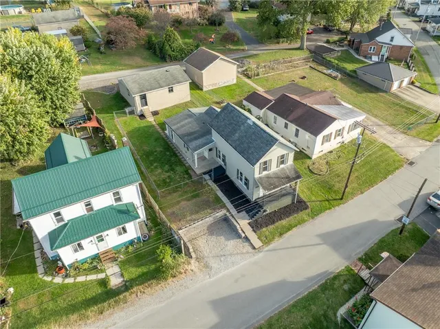 an aerial view of a house with a garden and parking space