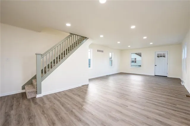 a view of an empty room with wooden floor