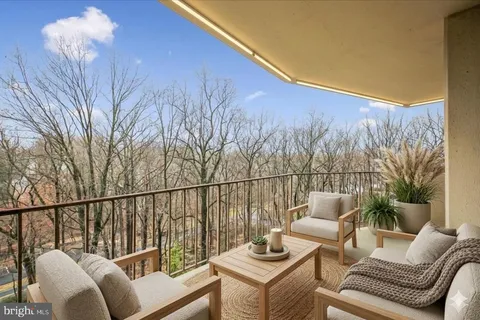 a roof deck with couches and wooden floor