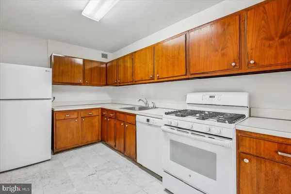 a kitchen with stainless steel appliances granite countertop cabinets and a stove top oven