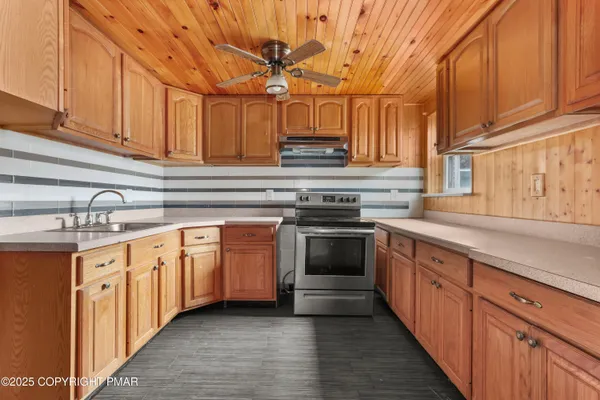 a kitchen with granite countertop a sink and cabinets