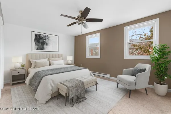a spacious bedroom that has a bed and a couch