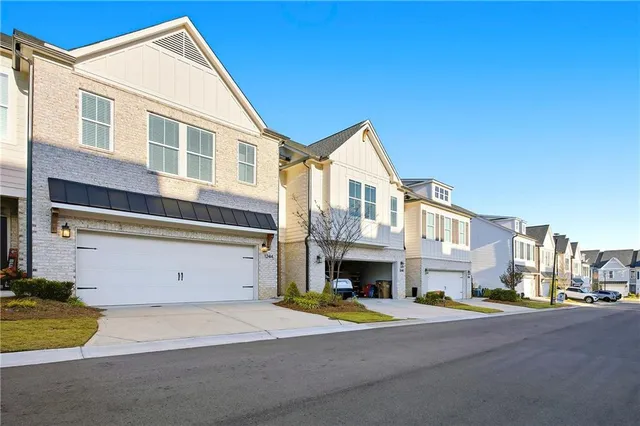 a front view of a residential apartment building with a yard