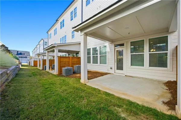 a front view of a residential apartment building with a yard