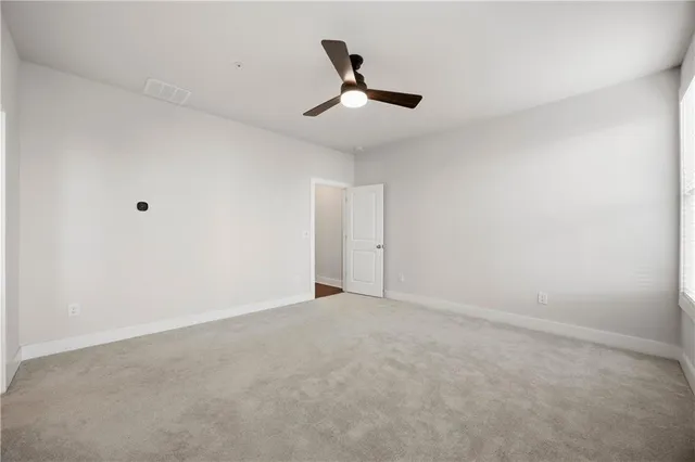 a bathroom with a granite countertop sink a mirror and a shower